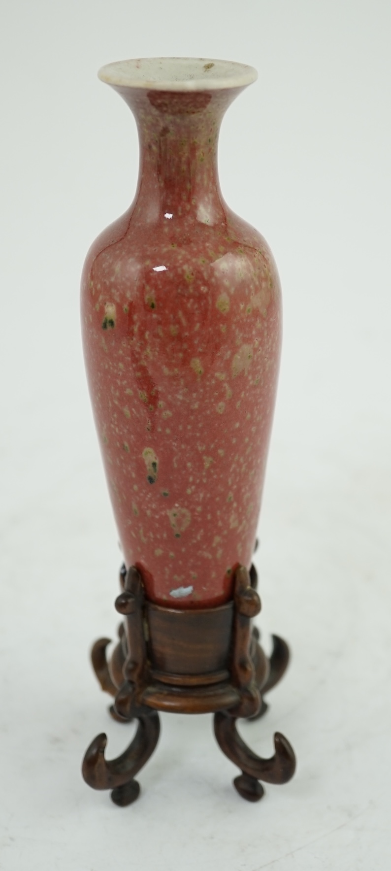 A small Chinese peach bloom glazed vase with fitted wood stand, Republic period